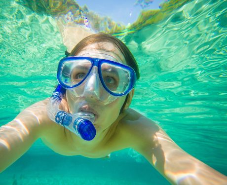 A woman snorkeling in the ocean of Bonaire